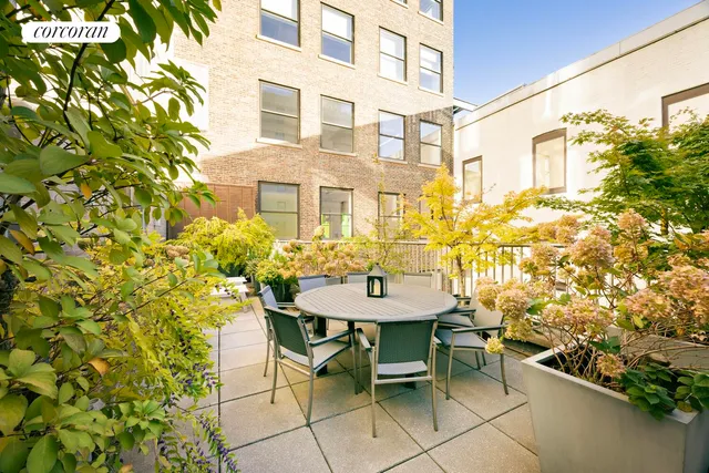 a view of an chairs and table in front of house