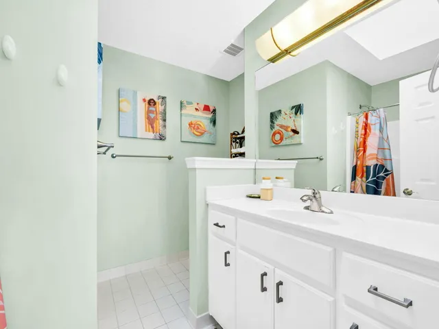 a living room with furniture a ceiling fan and a rug