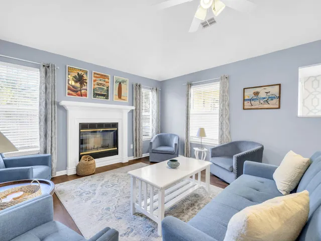 a kitchen with white cabinets a sink dishwasher and a stove with wooden floor