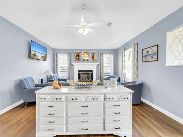 a view of a bedroom with furniture and wooden floor