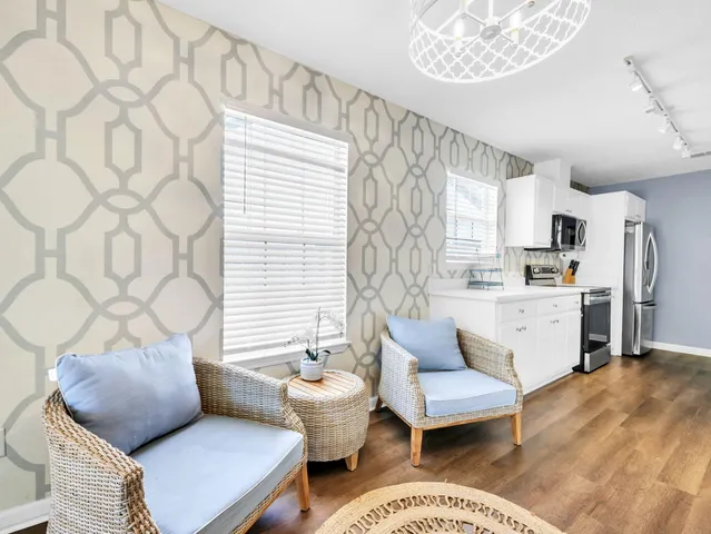 a view of a patio with table and chairs potted plants and wooden fence