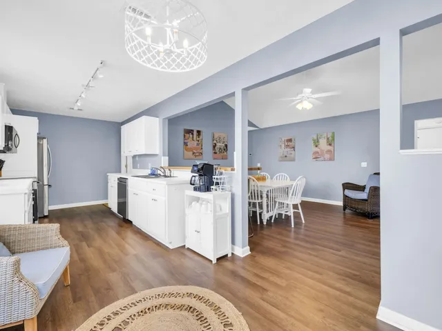 a view of a yard with plants and trees