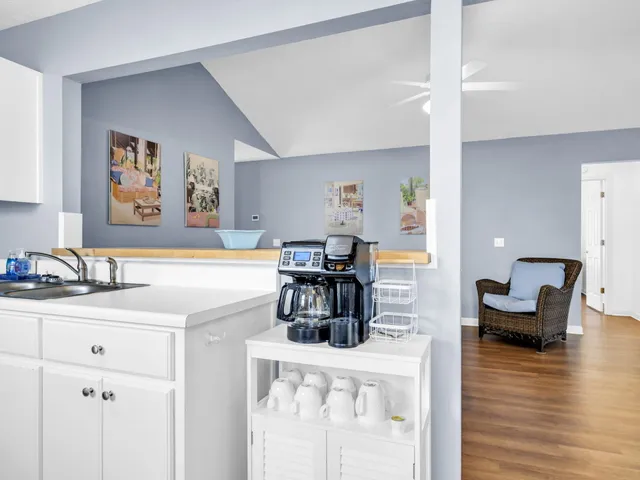 a view of backyard with table and chairs and a large tree