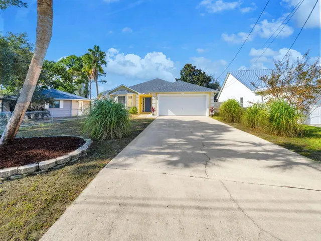a view of living room with furniture and a potted plant