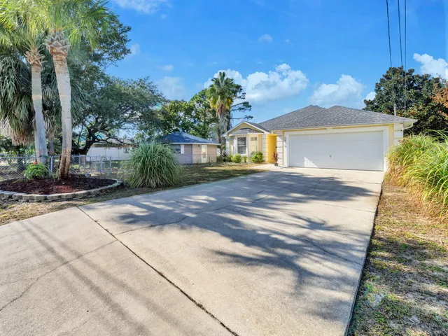 a bedroom with a large bed a large window and wooden floor