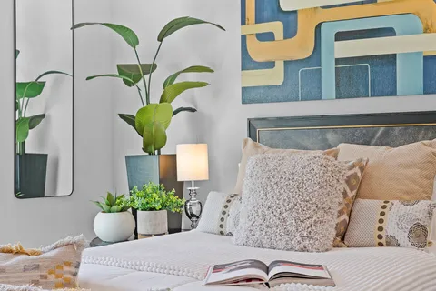 a living room with couches and potted plant