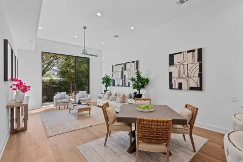 a dining room with furniture window and wooden floor