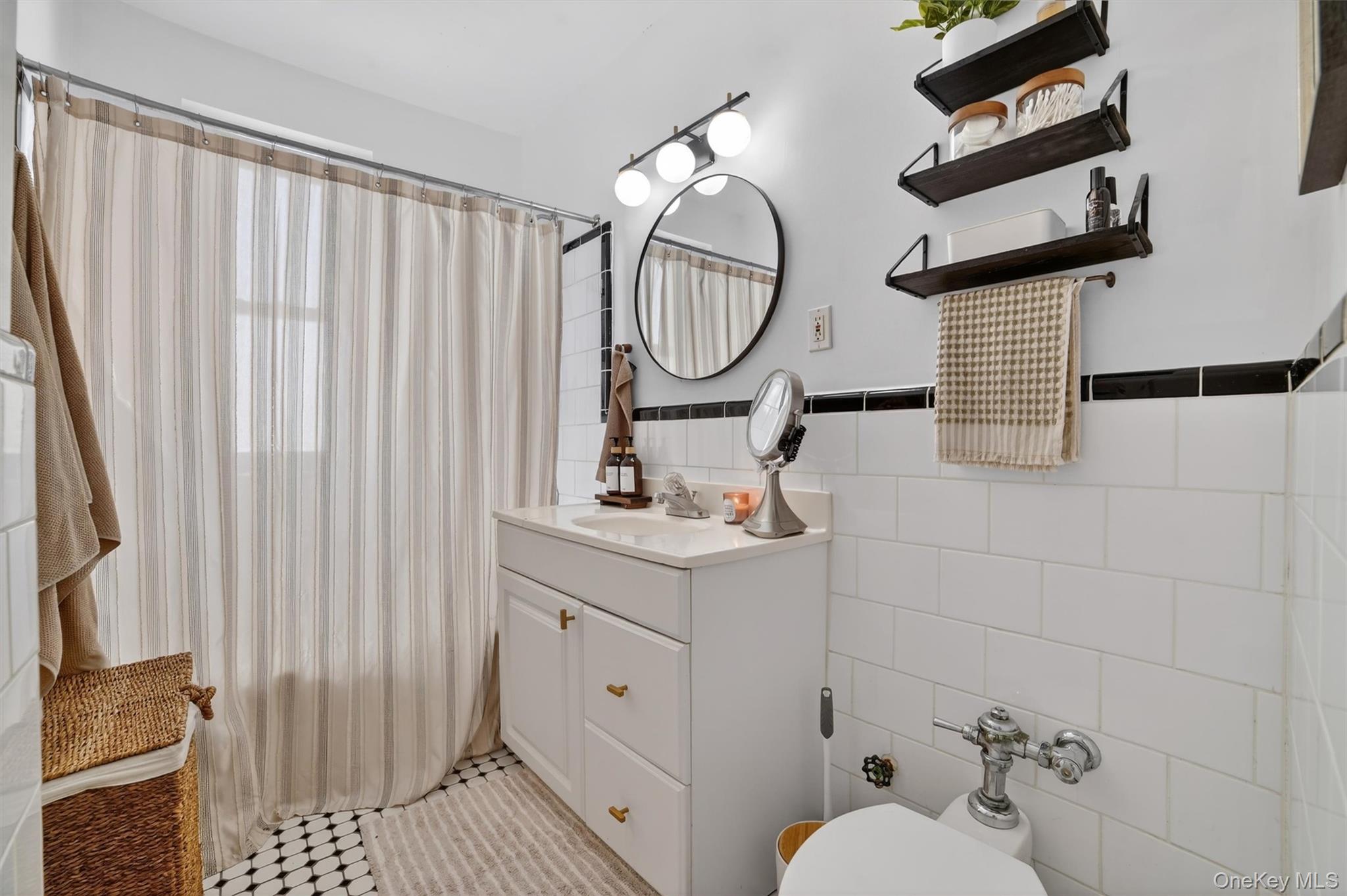 219 Bronx River Road, Unit 4N Yonkers, NY 10704 - Photo 25 of 30 a bathroom with a sink a toilet and a mirror