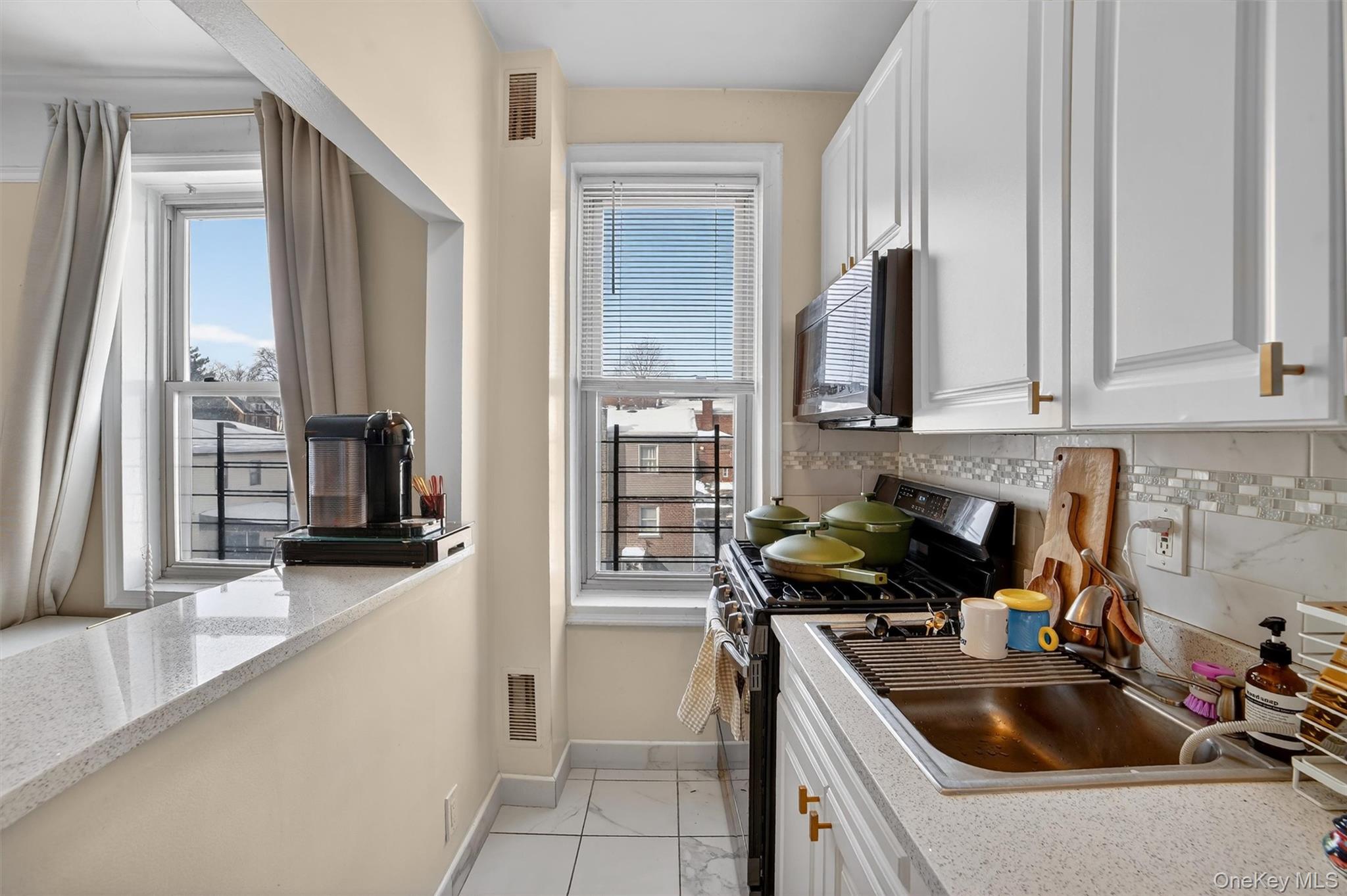 219 Bronx River Road, Unit 4N Yonkers, NY 10704 - Photo 7 of 30 a kitchen that has a sink and a stove