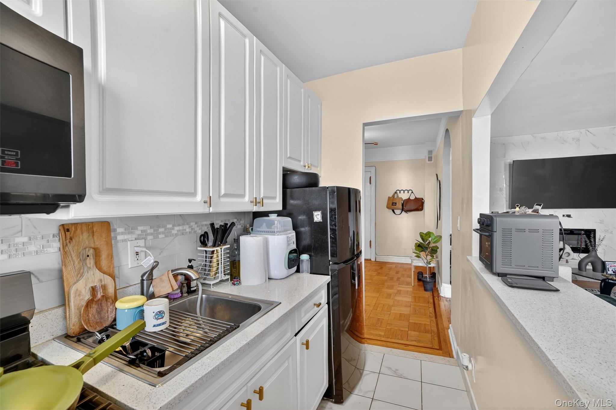219 Bronx River Road, Unit 4N Yonkers, NY 10704 - Photo 9 of 30 a kitchen with a stove and a microwave