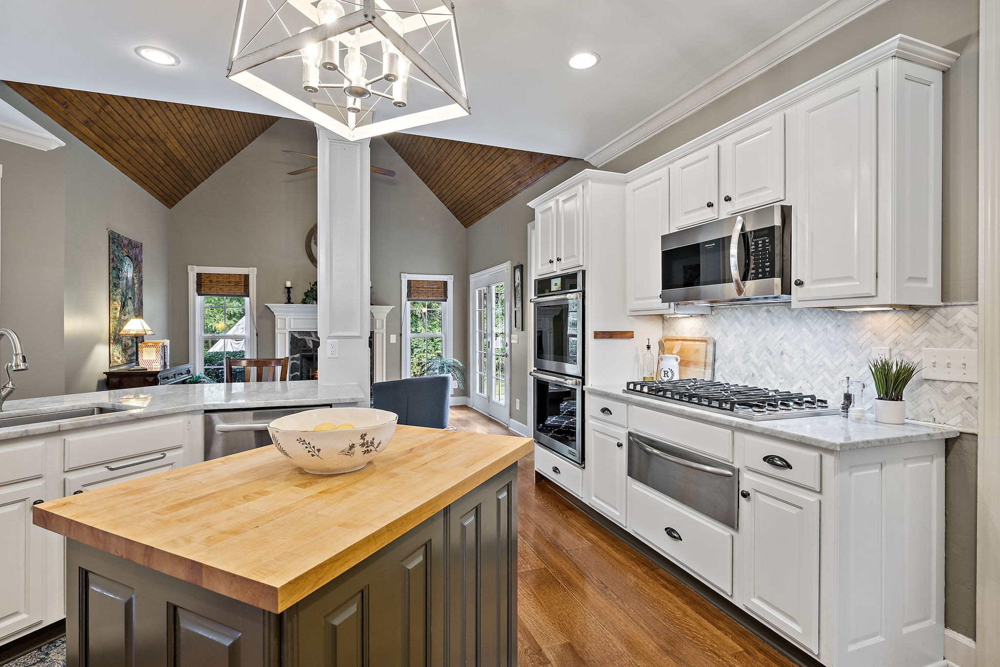 1420 Hunter Road Franklin, TN 37064 - Photo 18 of 57 a kitchen with stainless steel appliances kitchen island granite countertop a sink and cabinets