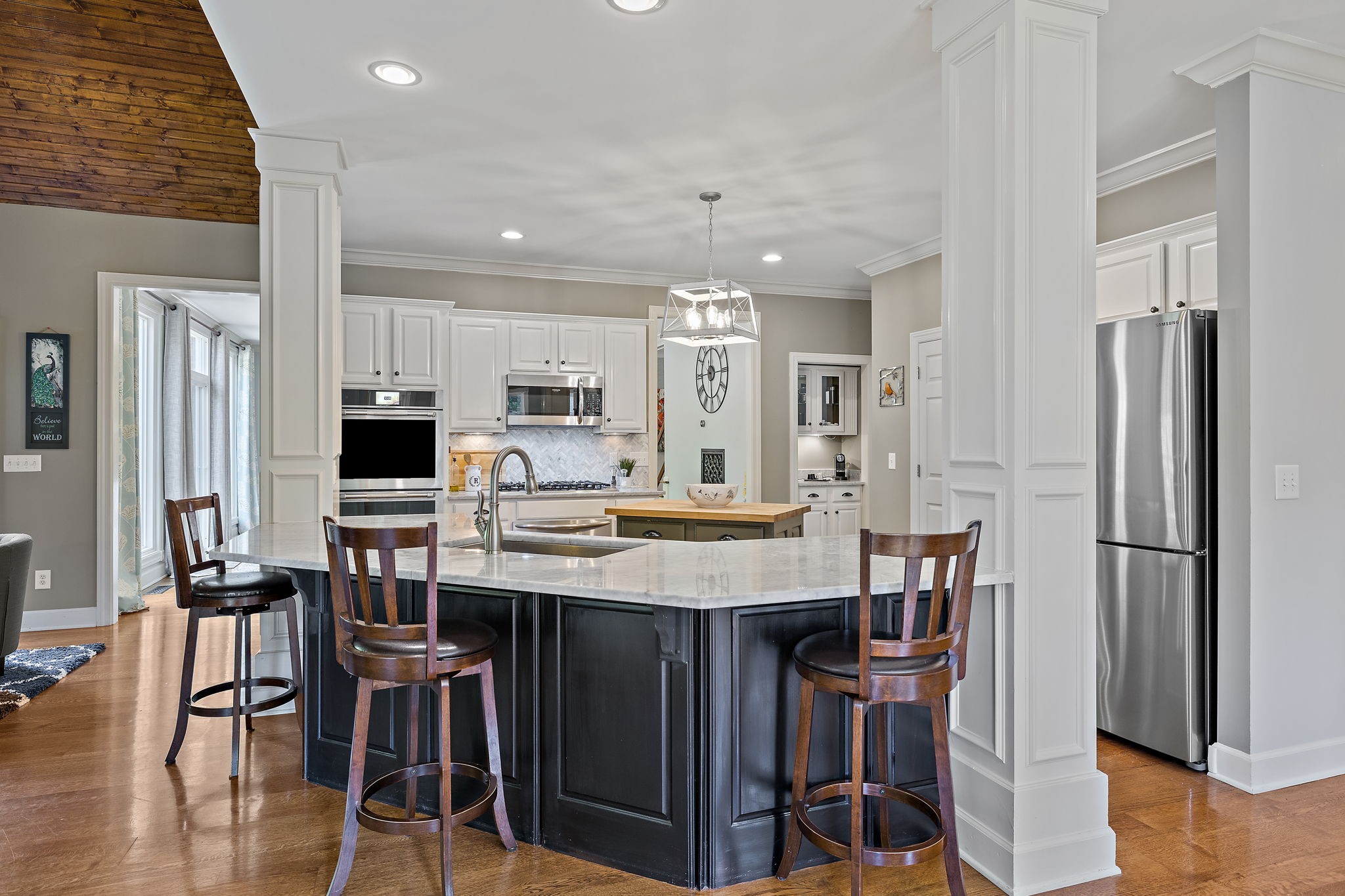 1420 Hunter Road Franklin, TN 37064 - Photo 20 of 57 a kitchen with stainless steel appliances kitchen island granite countertop a table chairs refrigerator and microwave