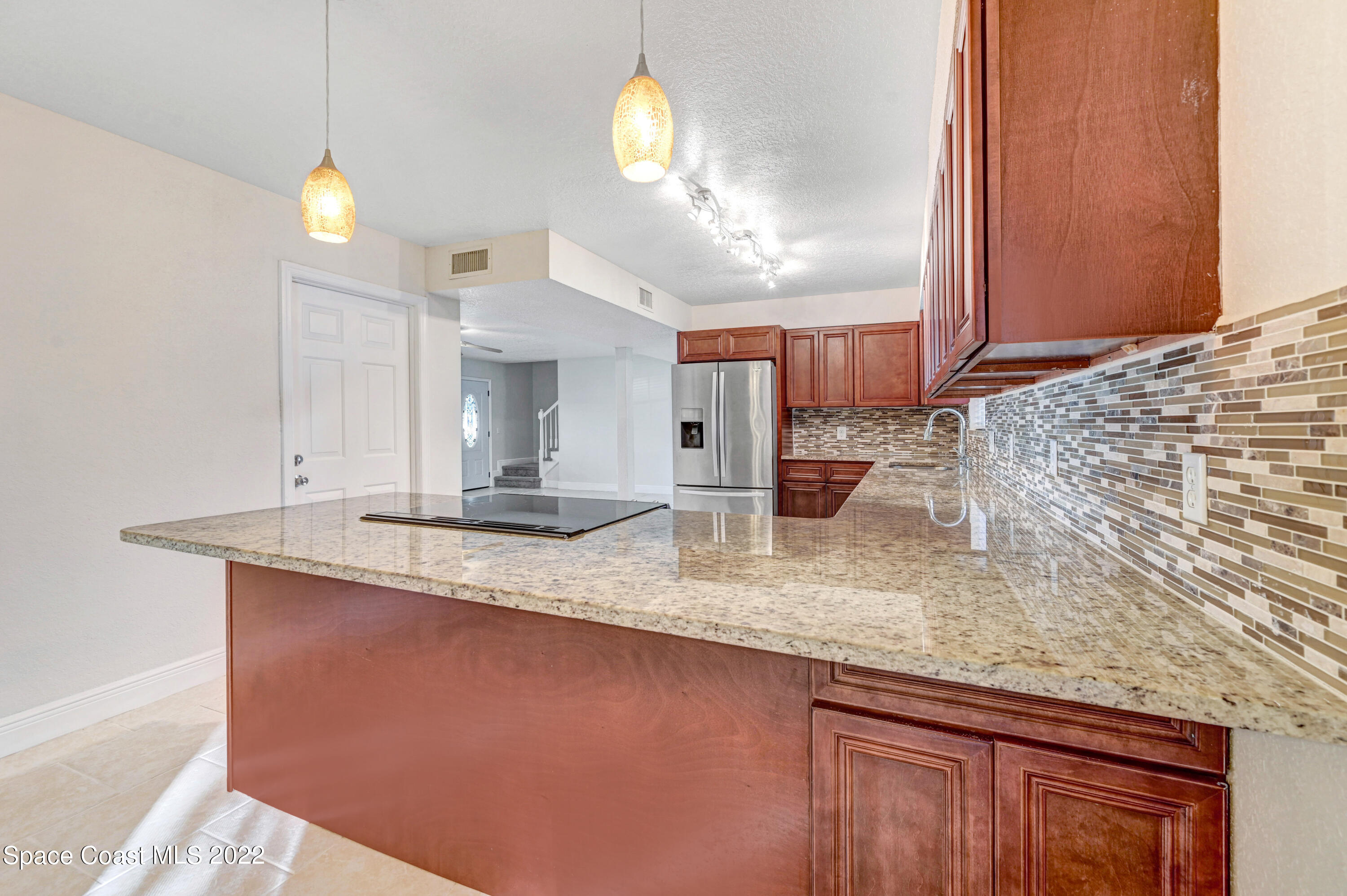 1074 Castile Road Southeast Palm Bay, FL 32909 - Photo 12 of 40 a bathroom with a sink granite and a light fixture