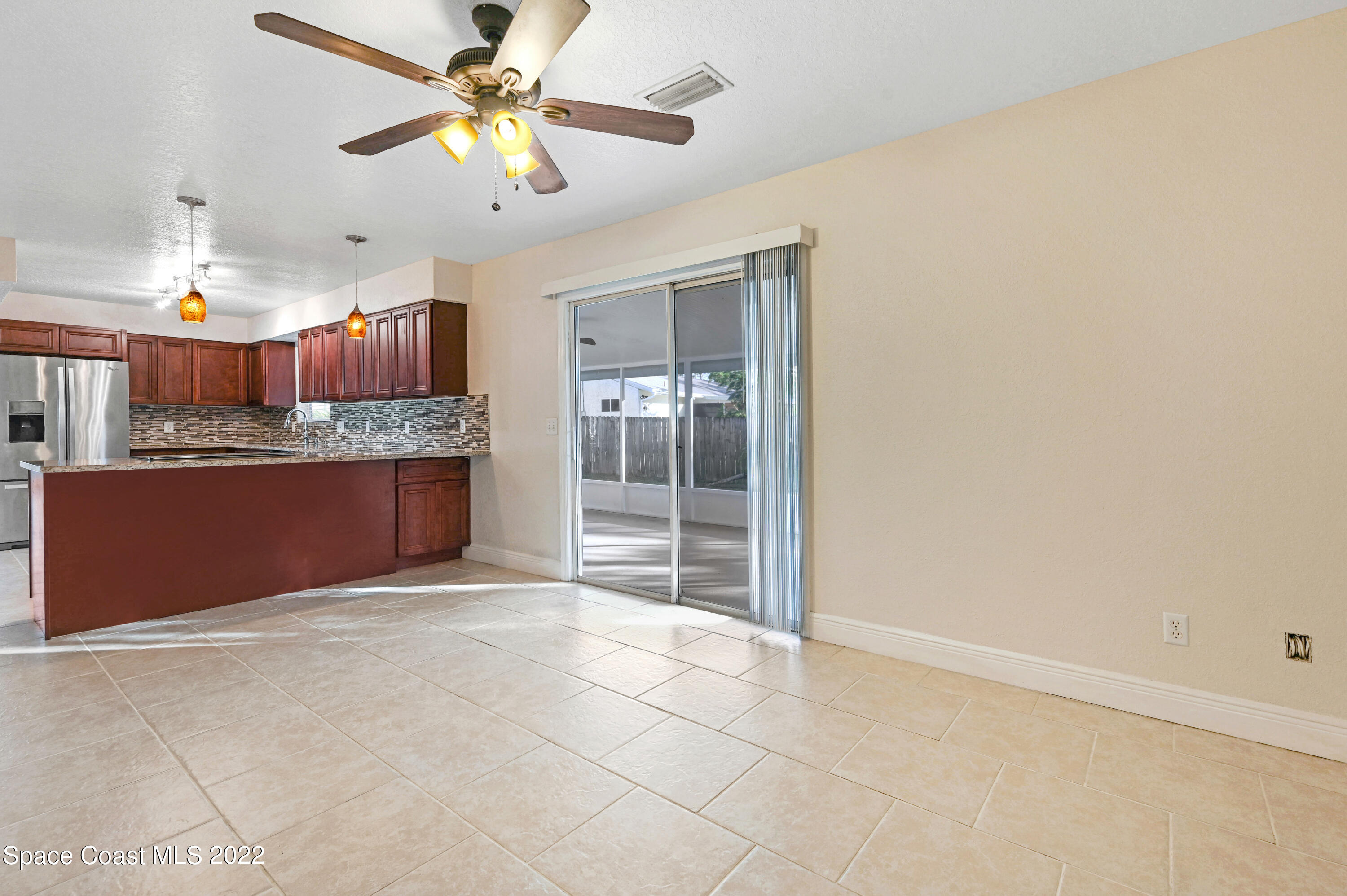 1074 Castile Road Southeast Palm Bay, FL 32909 - Photo 13 of 40 a view of a kitchen with a sink and a chandelier fan