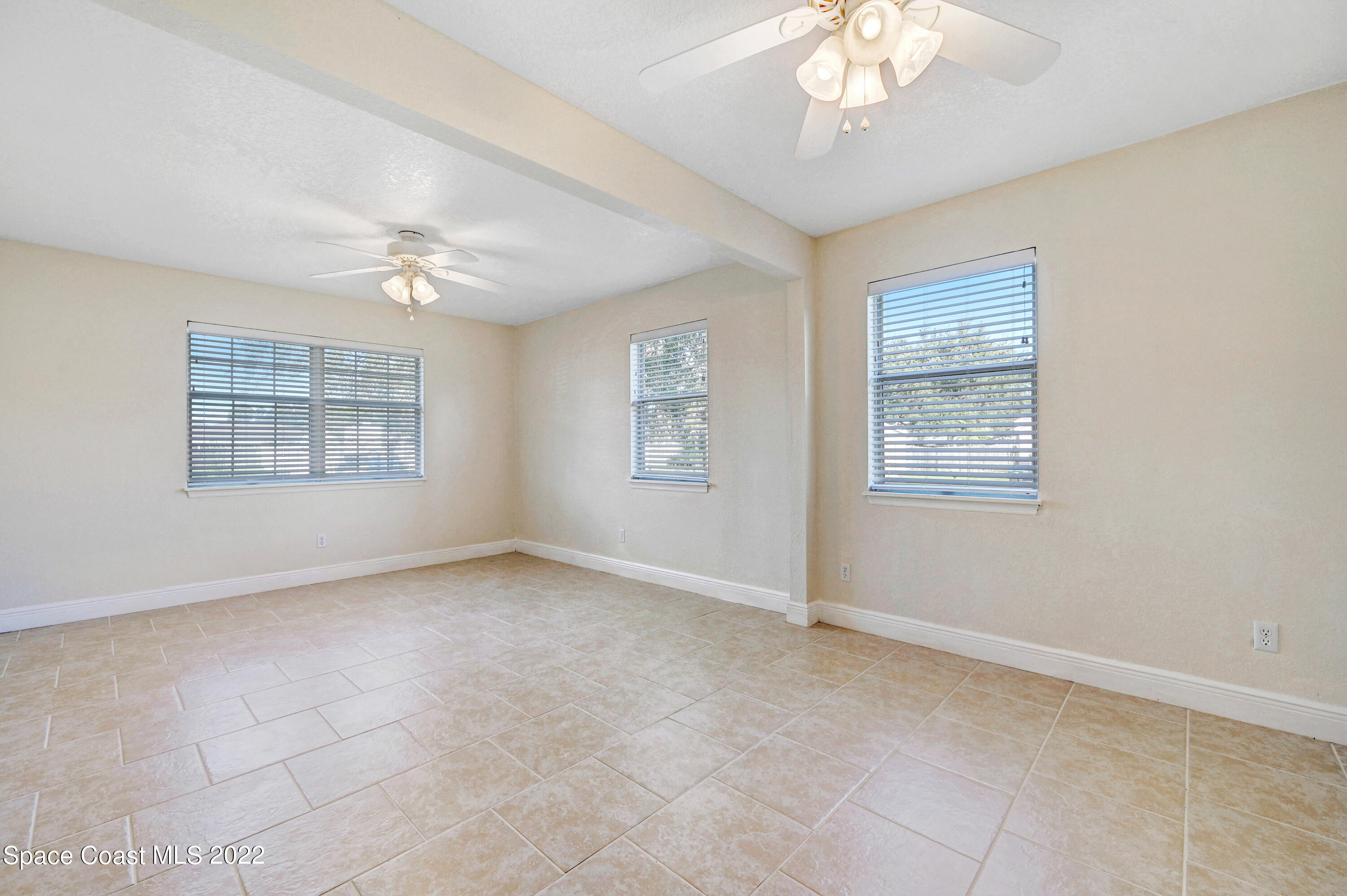 1074 Castile Road Southeast Palm Bay, FL 32909 - Photo 19 of 40 a view of an empty room with a window