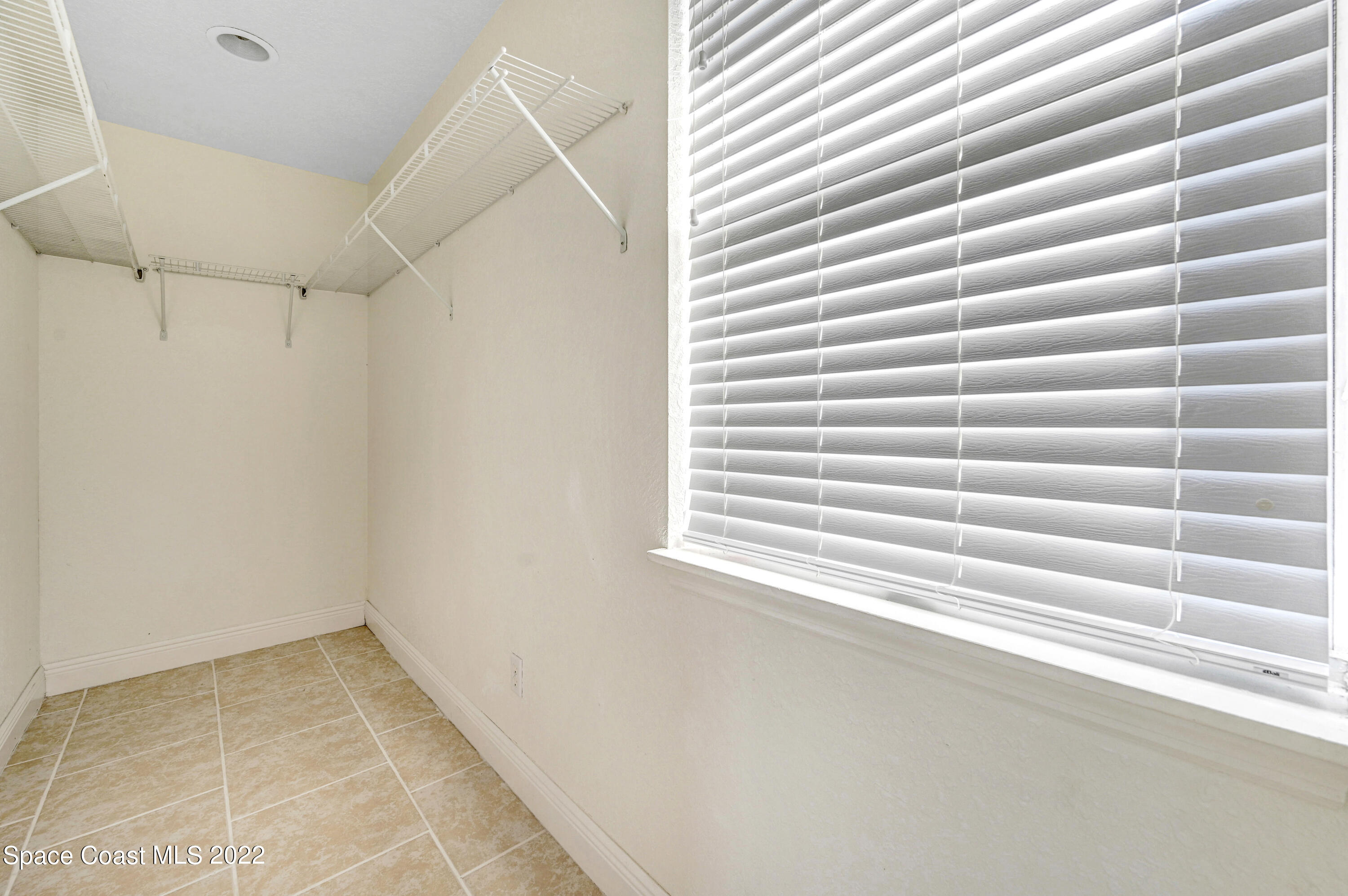 1074 Castile Road Southeast Palm Bay, FL 32909 - Photo 20 of 40 a view of a room that has a window and a white walls