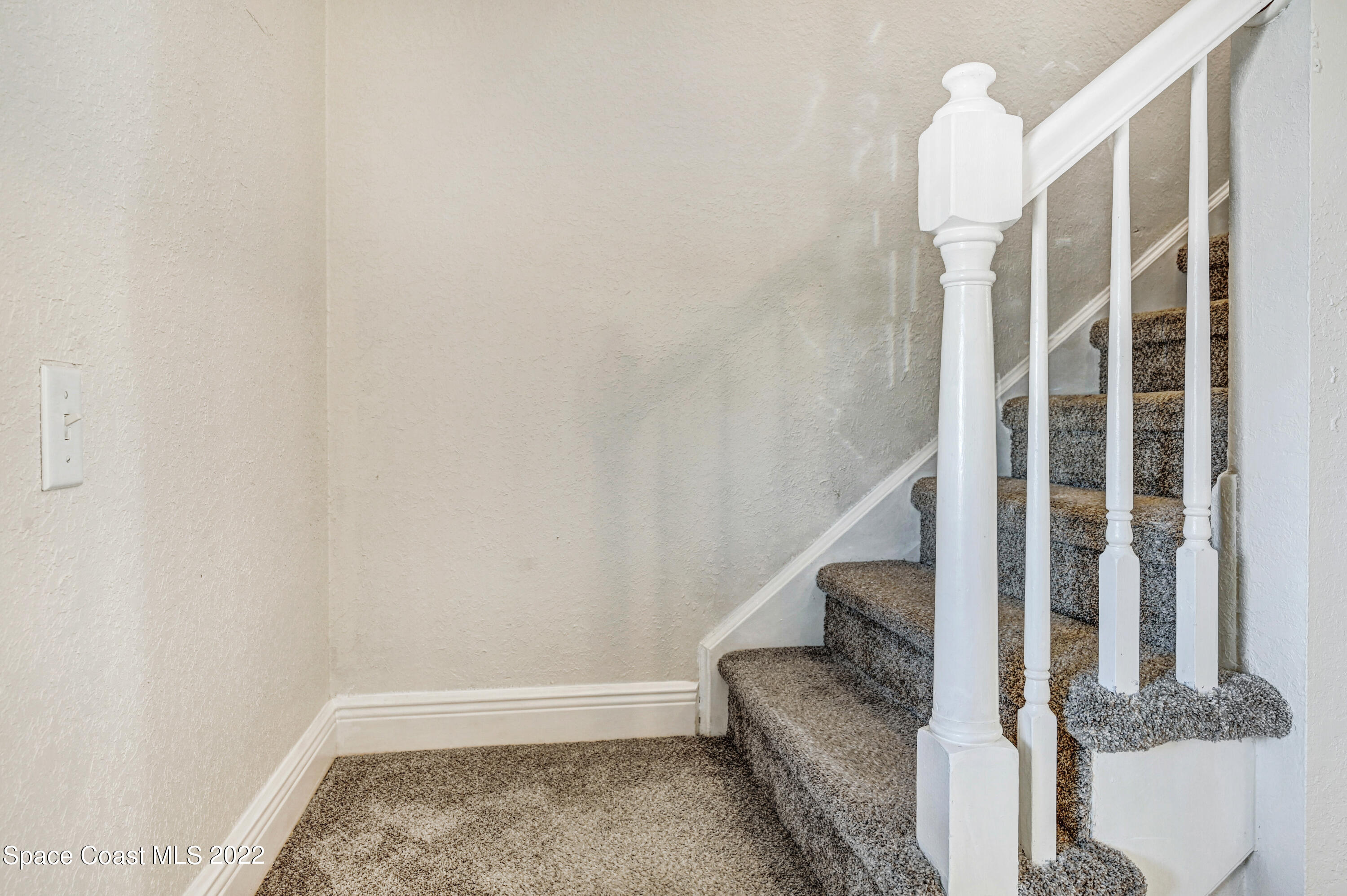 1074 Castile Road Southeast Palm Bay, FL 32909 - Photo 22 of 40 a view of staircase with rug