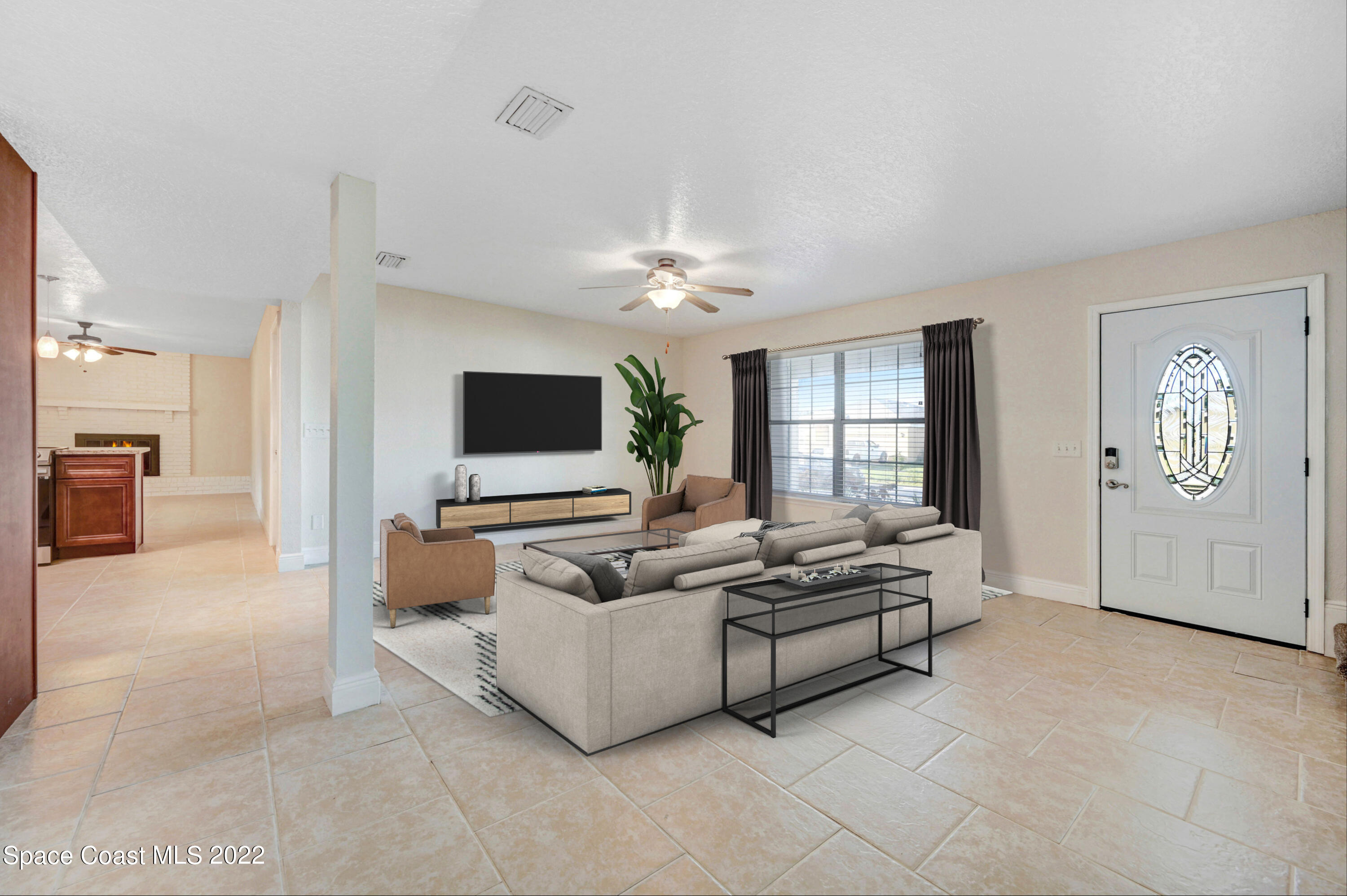 1074 Castile Road Southeast Palm Bay, FL 32909 - Photo 3 of 40 a living room with furniture and a flat screen tv