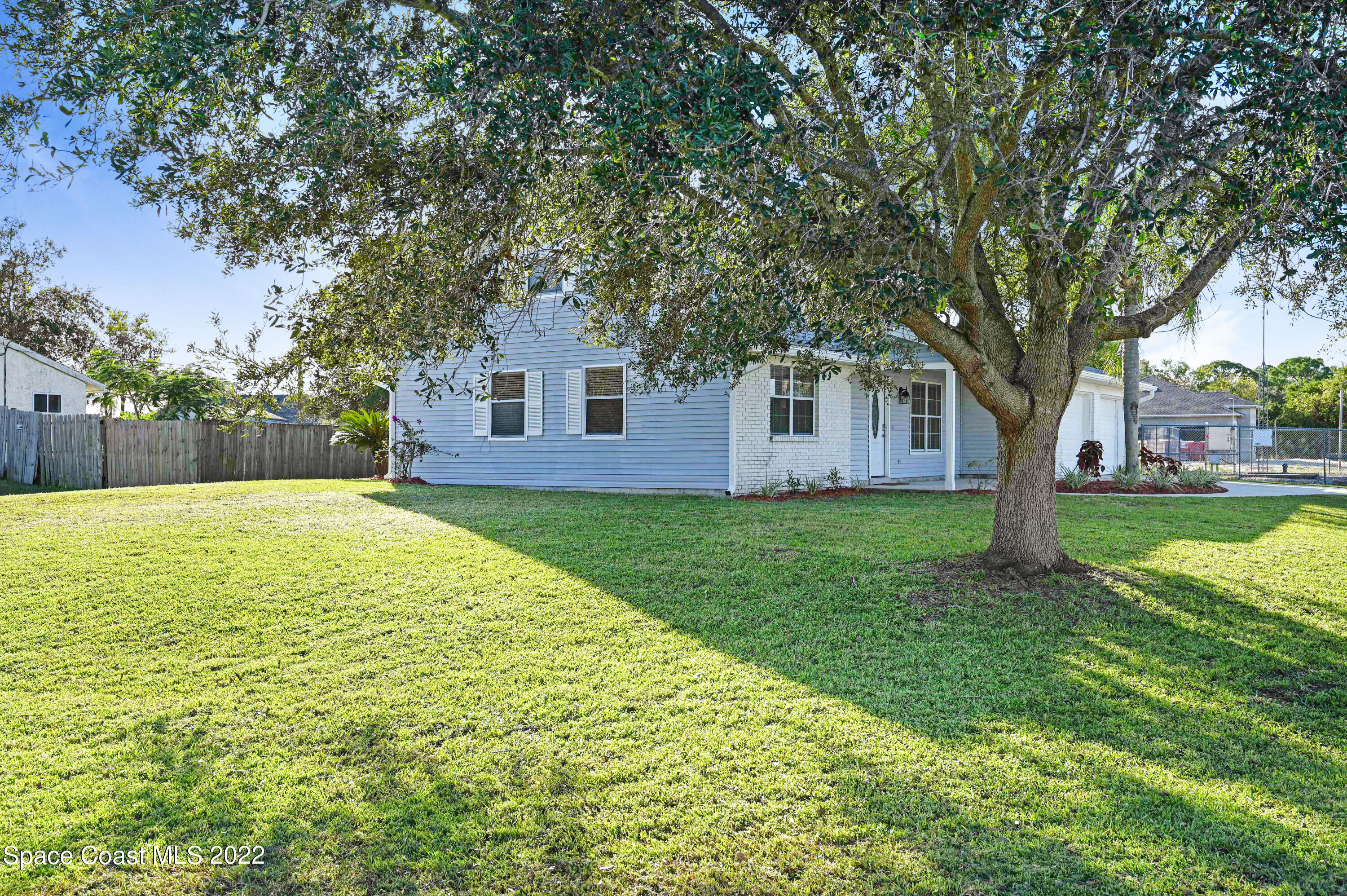 1074 Castile Road Southeast Palm Bay, FL 32909 - Photo 35 of 40 a house view with a garden space