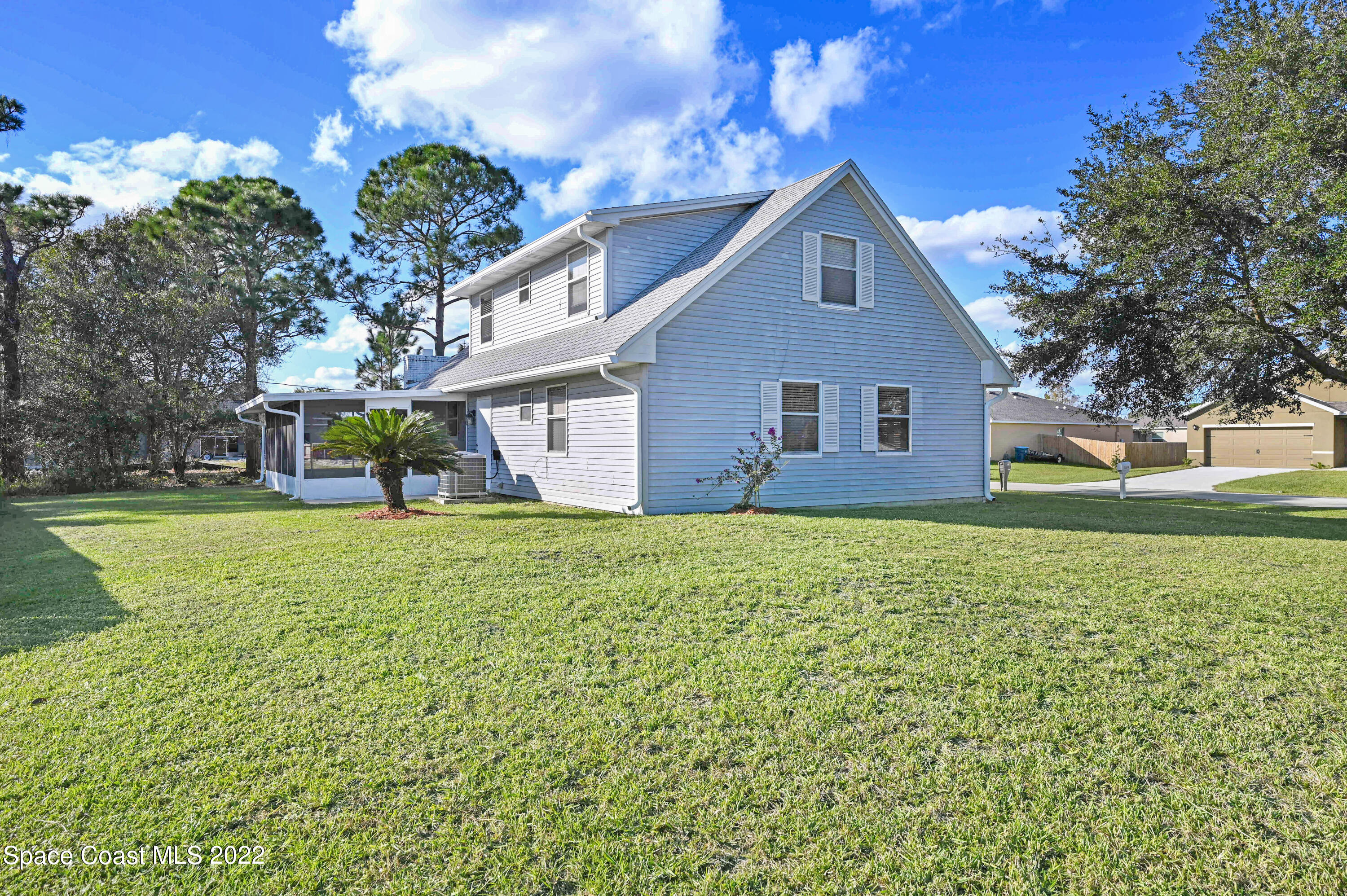 1074 Castile Road Southeast Palm Bay, FL 32909 - Photo 36 of 40 a front view of house with yard and green space