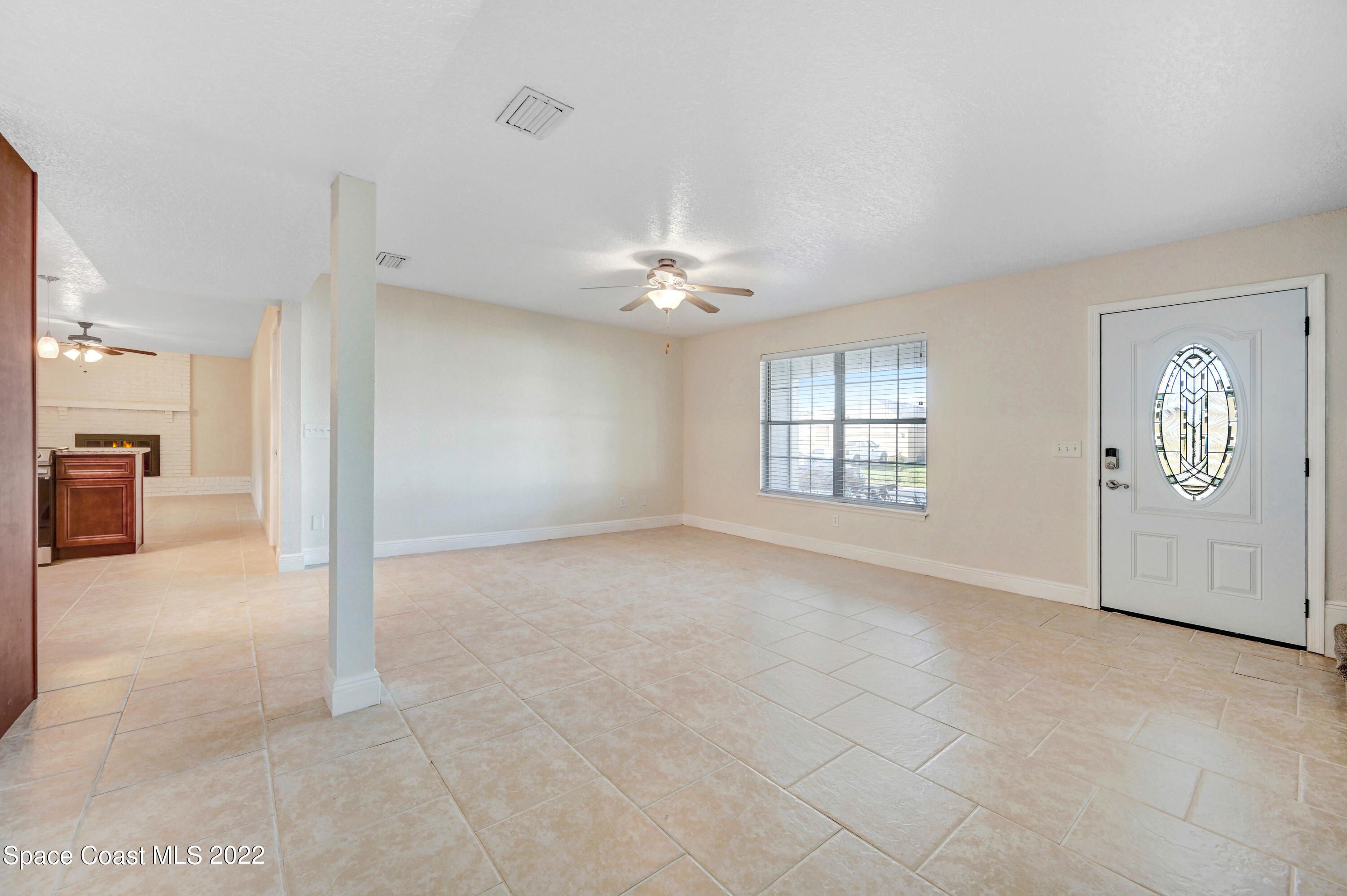 1074 Castile Road Southeast Palm Bay, FL 32909 - Photo 4 of 40 a view of a livingroom with a ceiling fan and window