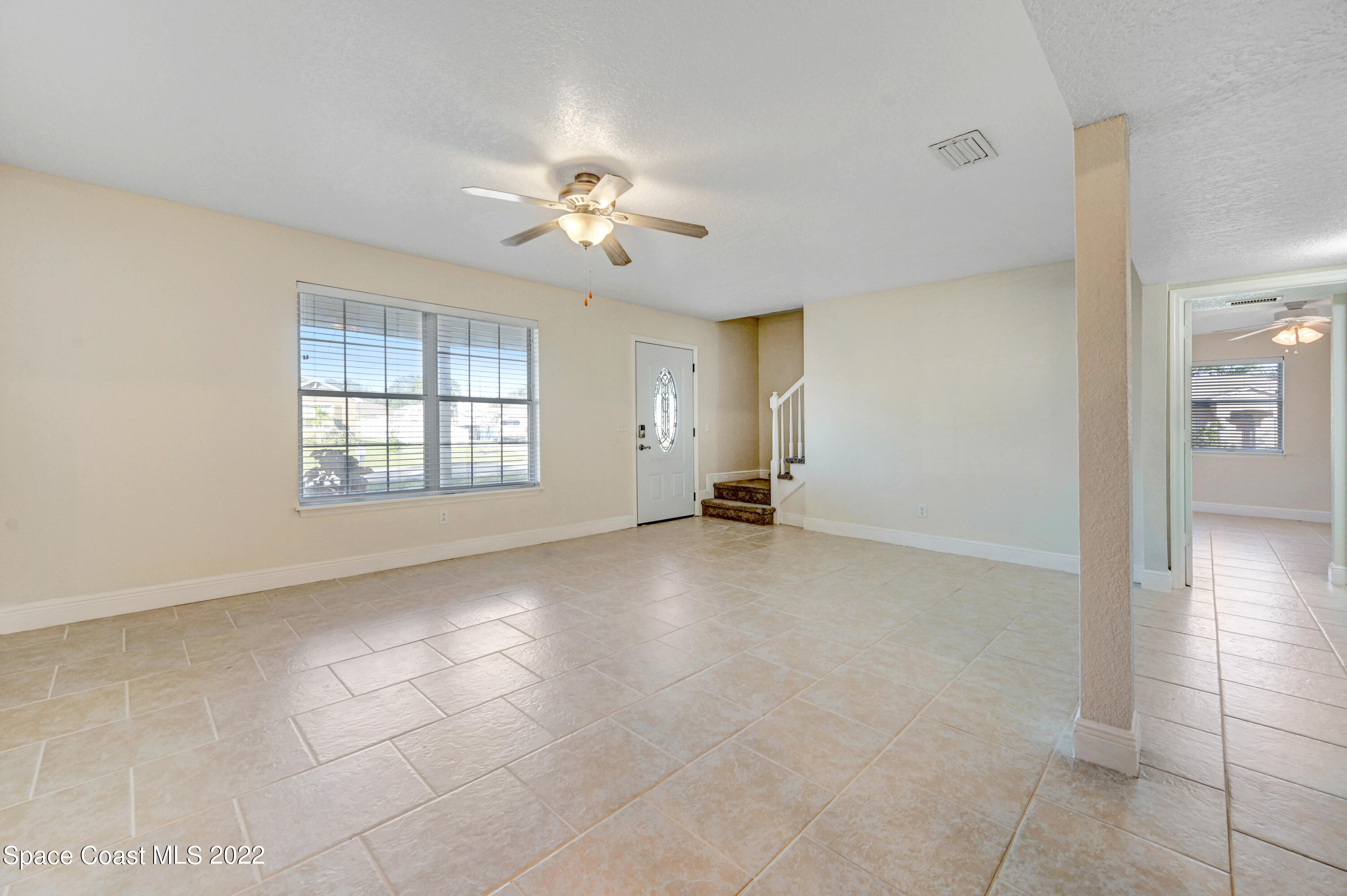 1074 Castile Road Southeast Palm Bay, FL 32909 - Photo 5 of 40 a view of an empty room with a window