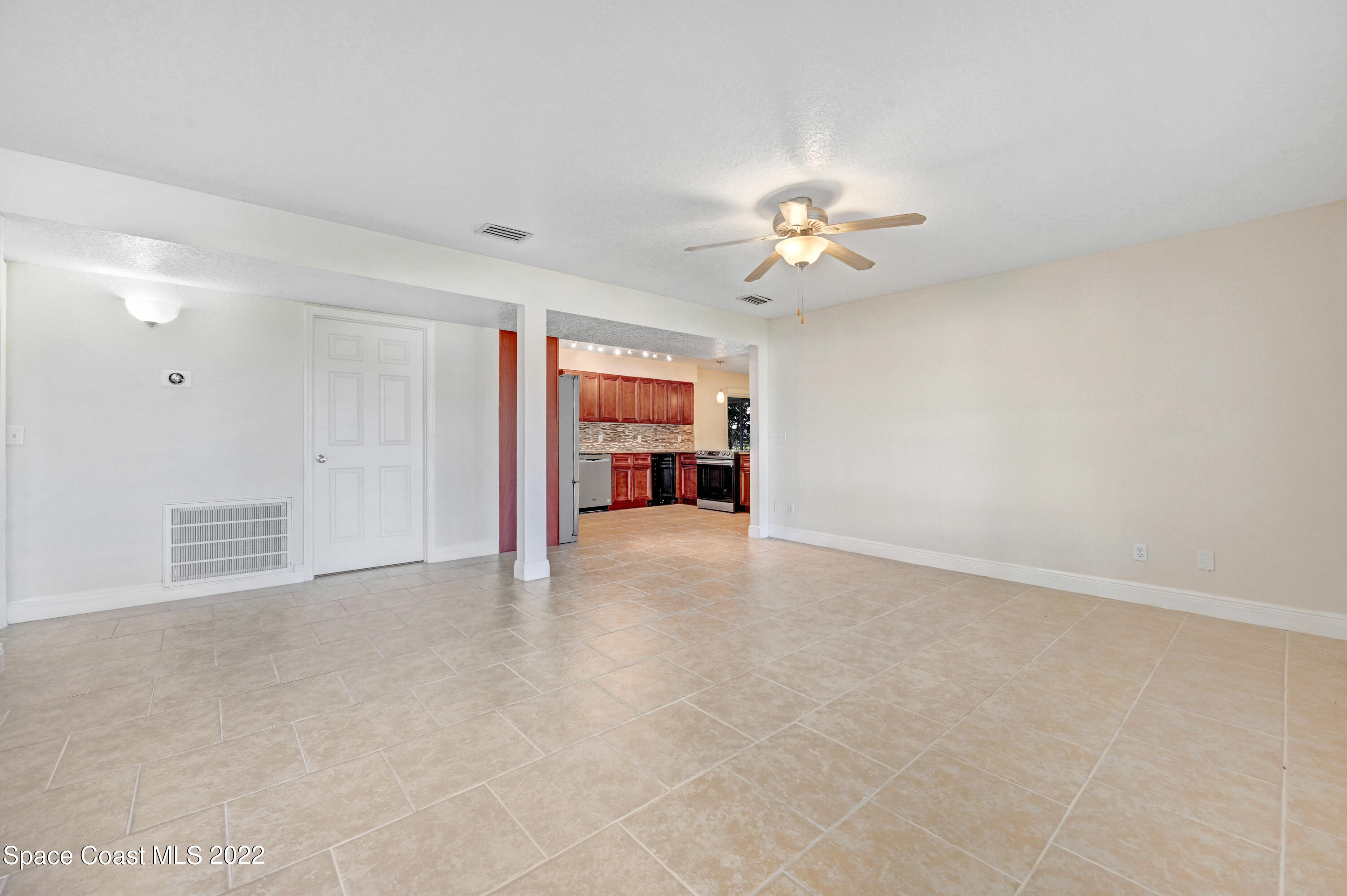 1074 Castile Road Southeast Palm Bay, FL 32909 - Photo 6 of 40 wooden floor in an empty room with a window