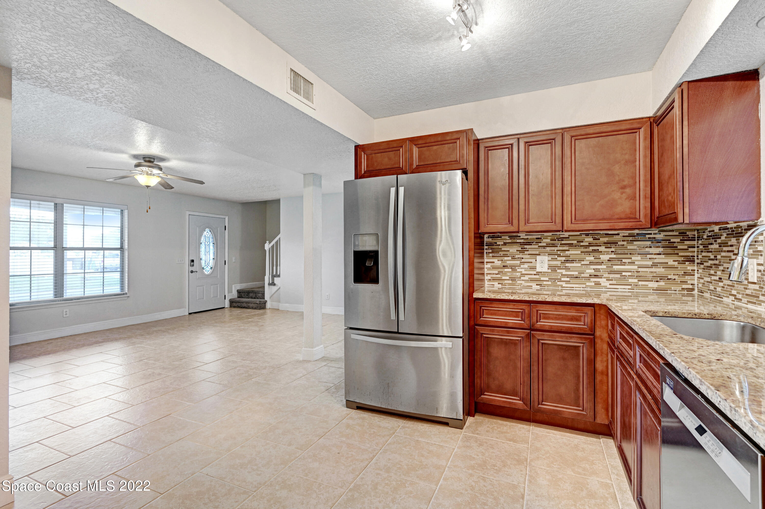 1074 Castile Road Southeast Palm Bay, FL 32909 - Photo 8 of 40 a kitchen with stainless steel appliances granite countertop a refrigerator and a sink