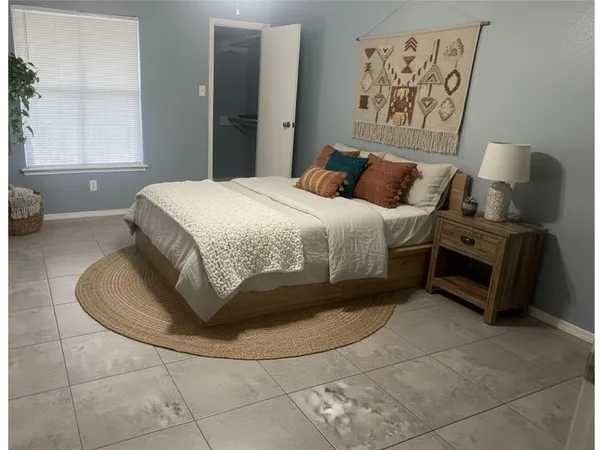 a bedroom with a bed and a window