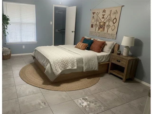 a bedroom with a bed and a window