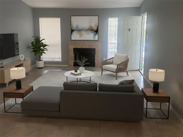 a living room with furniture and a fireplace