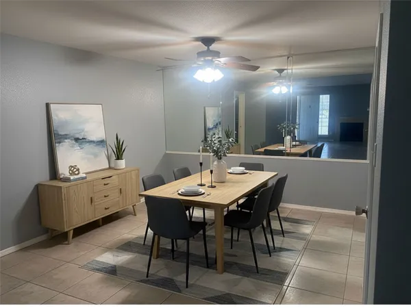 a dining room with a table chairs and a kitchen view