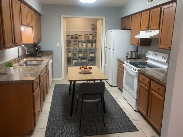 a kitchen with a stove sink and refrigerator