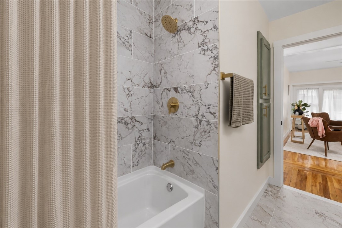 461 River Road Lincoln, RI 02865 - Photo 20 of 32 The full bathroom features a tub/shower combination and is conveniently located off the main hallway, providing easy access from the bedrooms and living room.