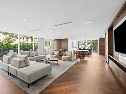 a living room with furniture tv and large window