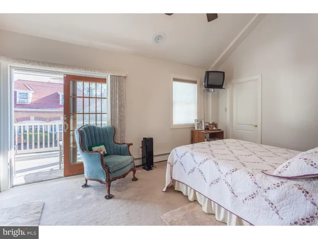 a bedroom with a bed and a chair