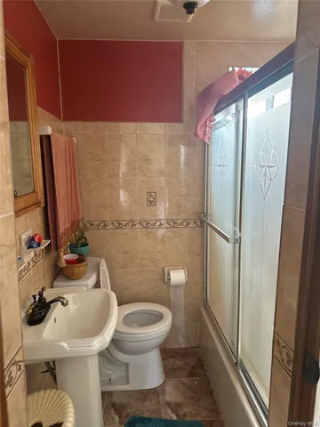 a bathroom with a toilet sink and shower