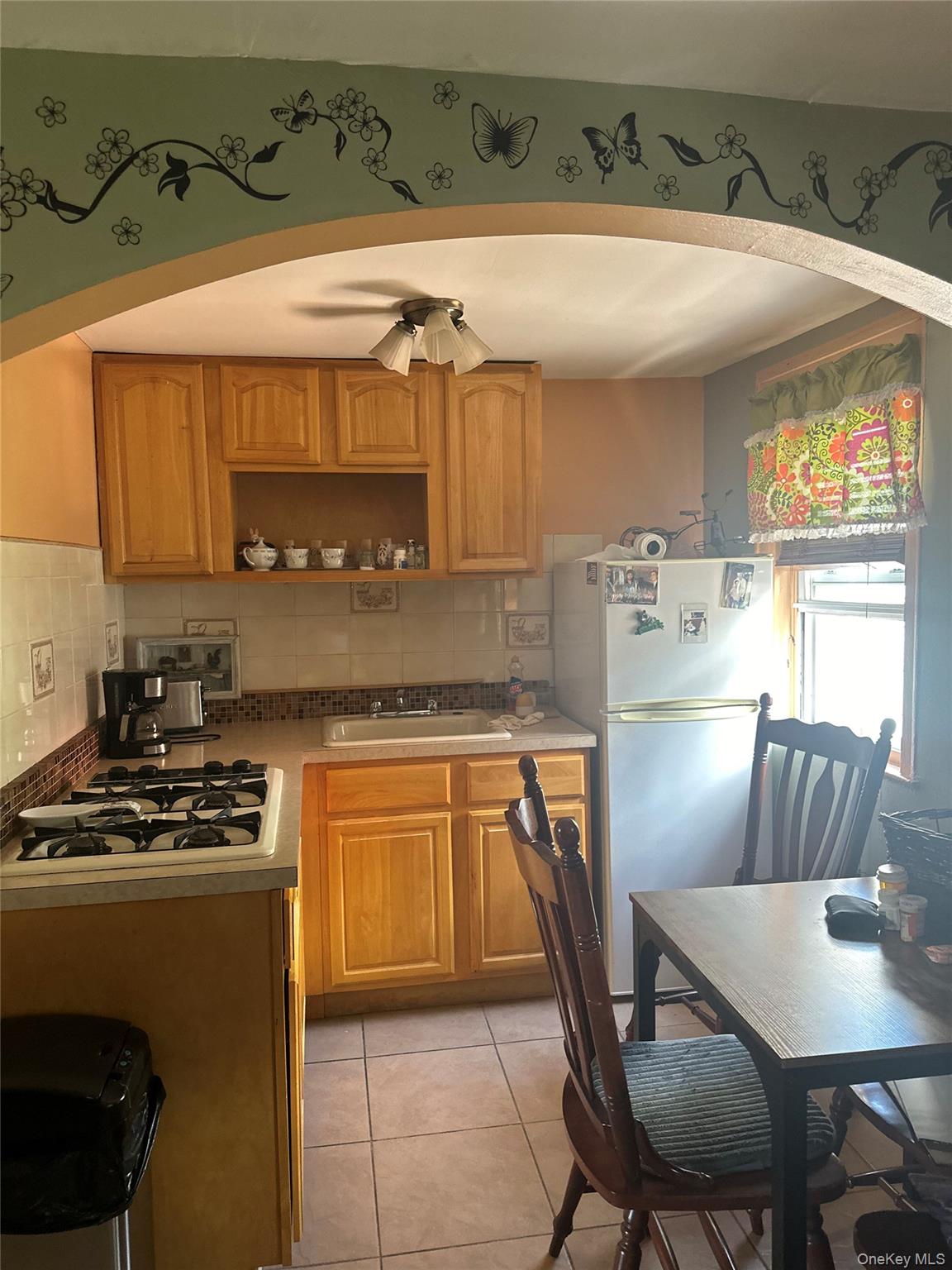 28 Maspeth Avenue Brooklyn, NY 11211 - Photo 13 of 21 a kitchen with stainless steel appliances a stove a sink cabinets and a dining table