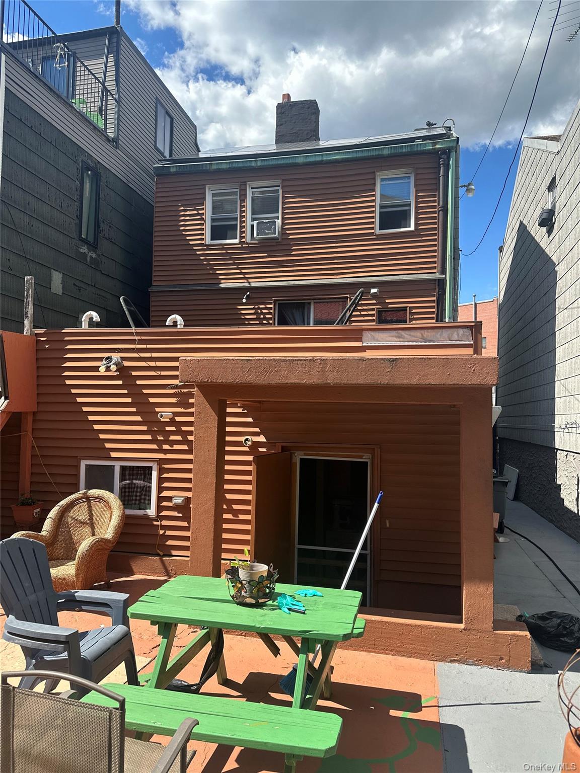 28 Maspeth Avenue Brooklyn, NY 11211 - Photo 16 of 21 a front view of house with yard outdoor seating and garage