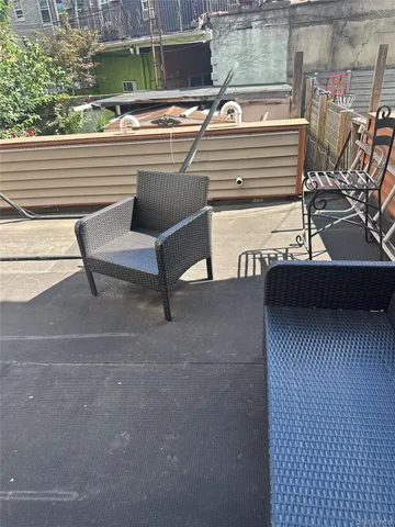 a view of a patio with a table and chairs
