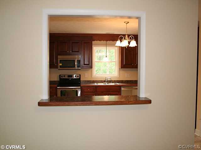 18 Winding Ridge Way Bumpass, VA 23024 - Photo 7 of 17 a view of kitchen with stainless steel appliances granite countertop a stove and a microwave