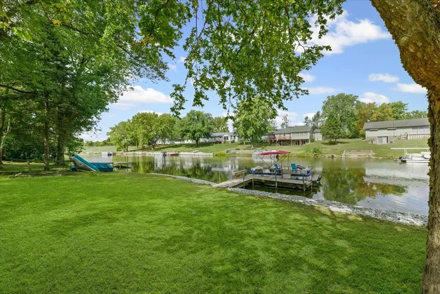 a view of a lake with a yard and trees
