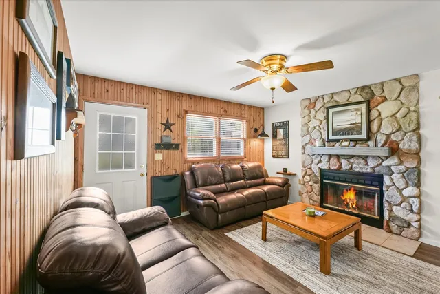 a living room with furniture a flat screen tv and a fireplace
