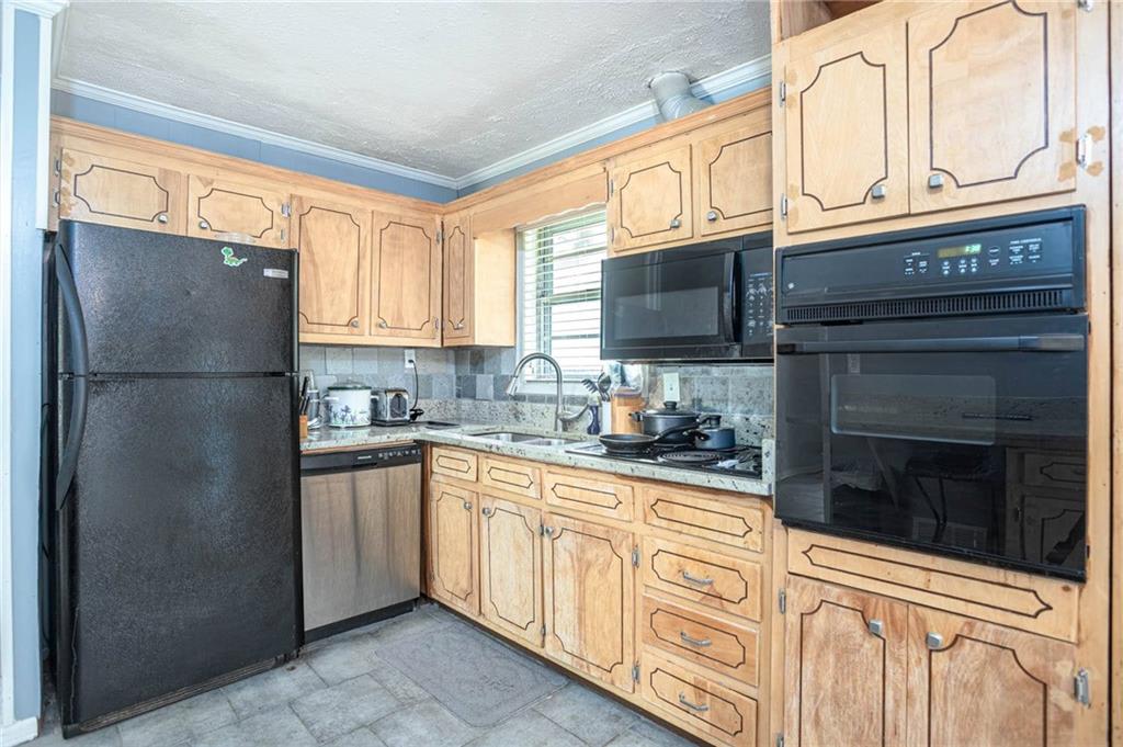 4123 Shorter Way Decatur, GA 30034 - Photo 7 of 14 a kitchen with stainless steel appliances granite countertop a refrigerator a stove a sink and dishwasher with a dishwasher