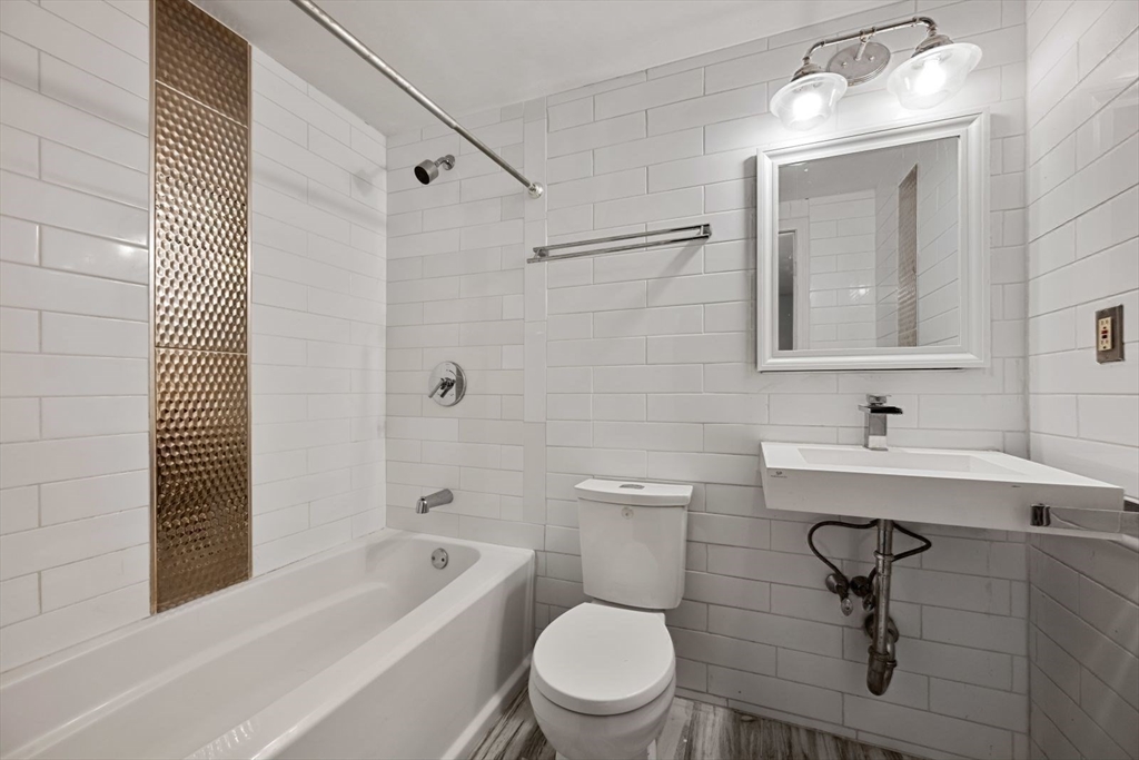 350 West Fourth Street, Unit 103 Boston, MA 02127 - Photo 17 of 33 a bathroom with a sink a toilet and shower