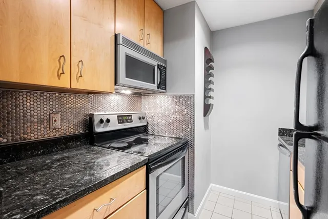 a view of kitchen with refrigerator and wooden floor