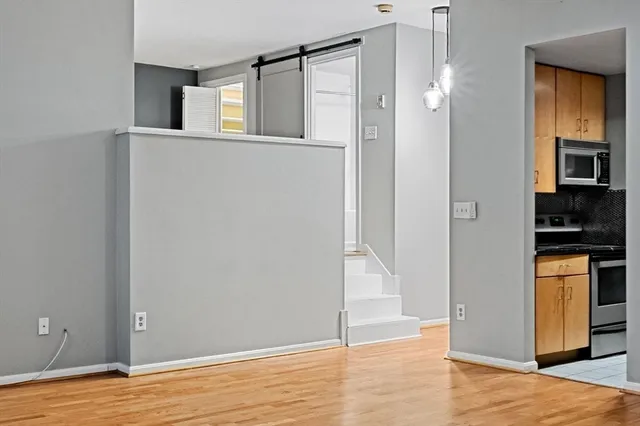 a view of empty room with wooden floor