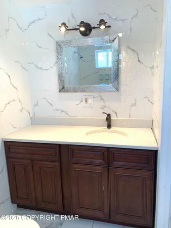 a white toilet sitting next to a bath tub and a shower