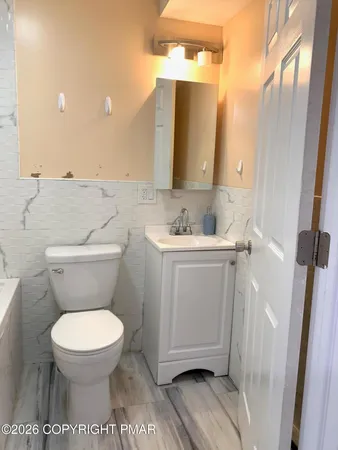 a bathroom with a bathtub and a toilet