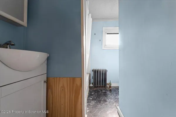 a white toilet sitting next to a window